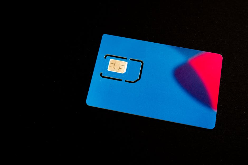 A blue SIM card on a dark background with vibrant red and purple accents