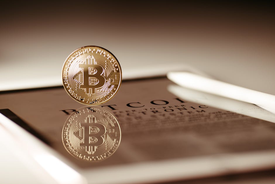 Close-up of a gold Bitcoin reflecting on a digital tablet screen, showcasing cryptocurrency concepts