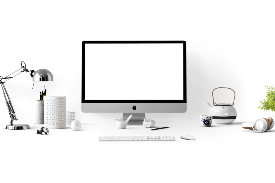 Minimalist office desk with an iMac, lamp, and stationary, perfect for tech backgrounds
